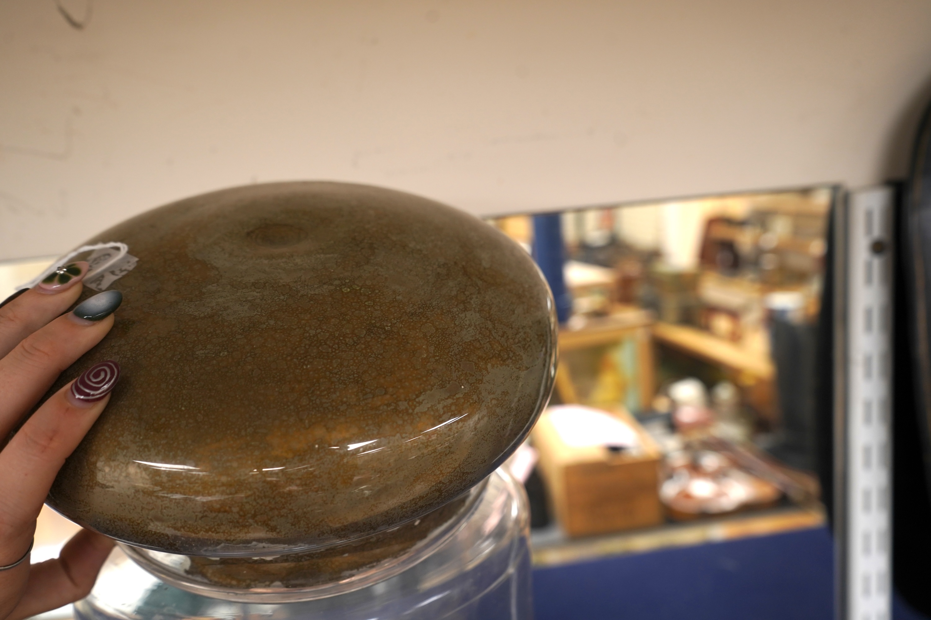 An 18th century cylindrical glass drug jar with remnants of gilding to the lid, 42cm high